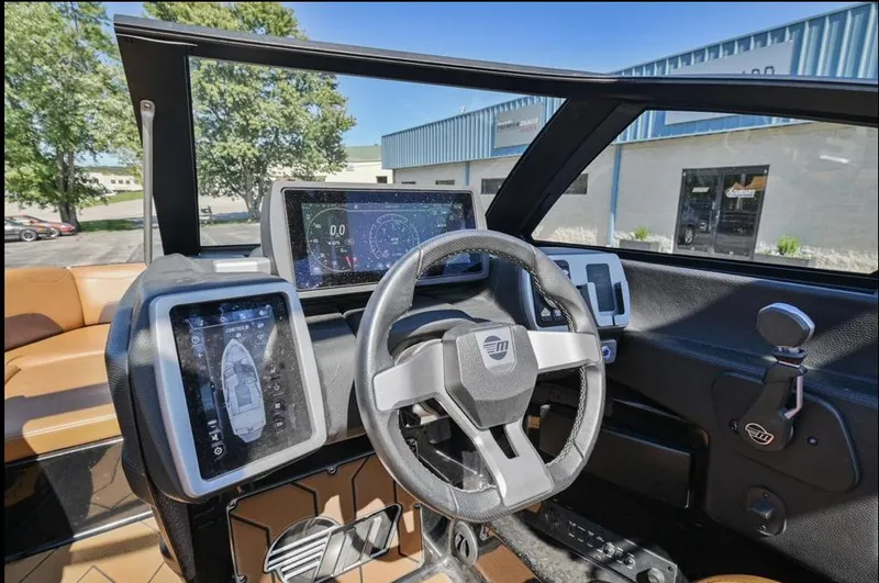 Slide: The Image of 2020 Malibu Wakesetter 23 LSV dashboard with modern controls and touchscreen displays. - 13