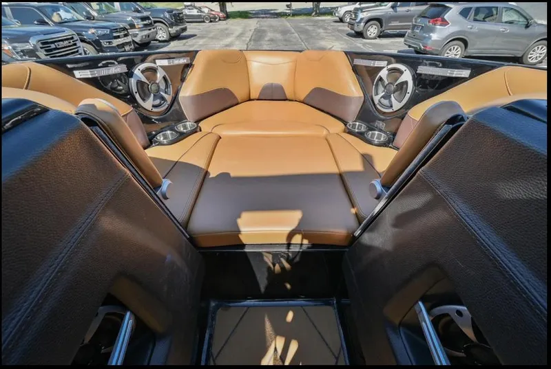 Slide: The Image of 2020 Malibu Wakesetter 23 LSV interior with tan leather seating and cup holders. - 14