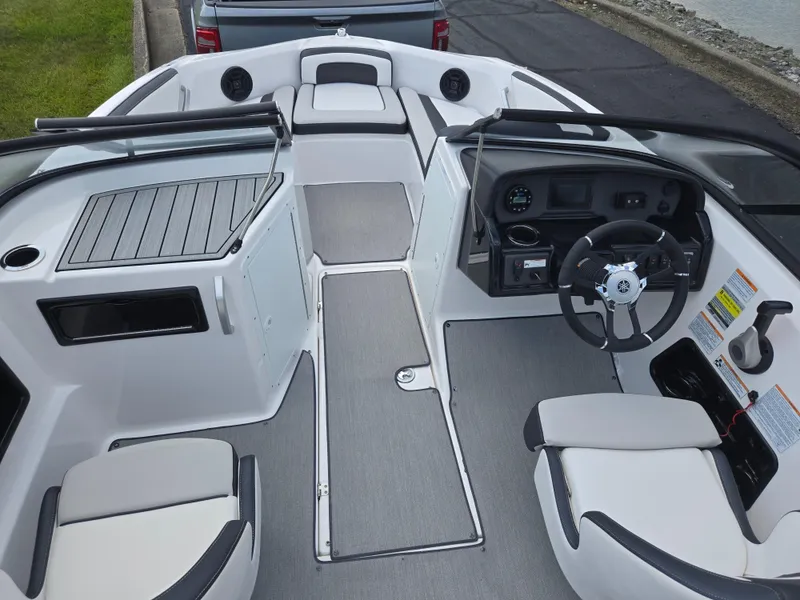 Slide: The Image of 2021 Yamaha Boats SX195 interior with steering wheel, seating, and dashboard controls. - 11
