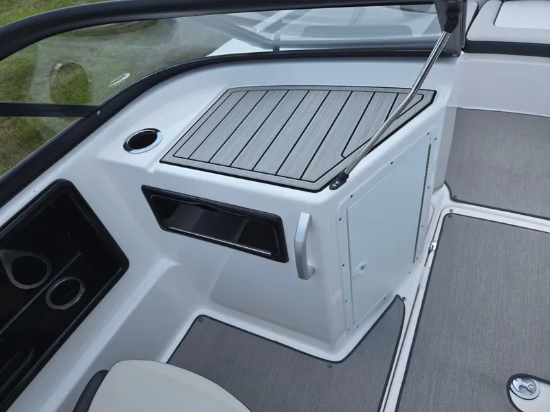 Slide: The Image of 2021 Yamaha Boats SX195 interior with sleek design and storage compartment. - 12
