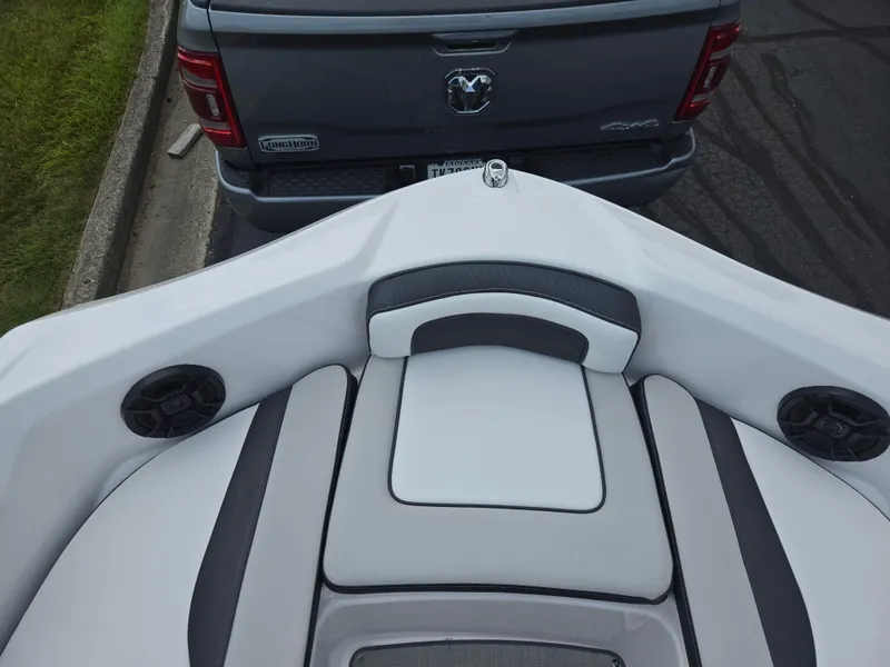 Slide: The Image of 2021 Yamaha SX195 boat interior near a parked truck. - 19