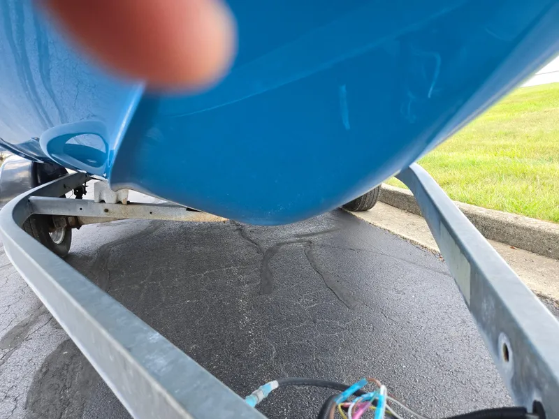 Slide: The Image of 2021 Yamaha Boats SX195 on trailer, close-up view of hull and trailer frame. - 7