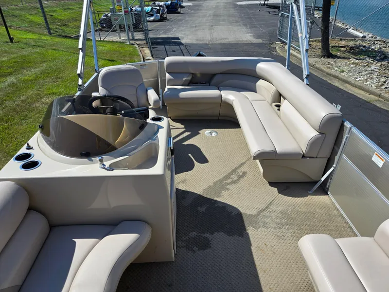 Slide: The Image of 2013 Starcraft Stardeck 190 Cruise pontoon boat interior with beige seating and steering console. - 15