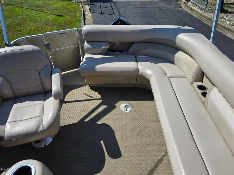 Slide: The Image of 2013 Starcraft Stardeck 190 Cruise boat interior with beige seating and carpeted floor. - 17