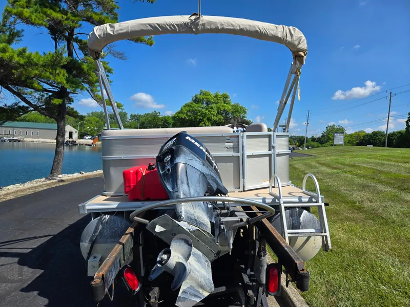 Slide: The Image of 2013 Starcraft Stardeck 190 Cruise pontoon boat on trailer by a lake. - 2