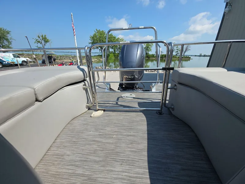 Slide: The Image of 2021 Bennington Q 23 Swingback with Yamaha outboard motor, parked outdoors. - 13