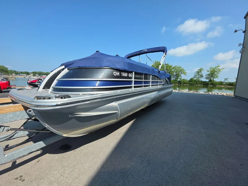 Slide: The Image of 2021 Bennington Q 23 Swingback pontoon boat with Yamaha outboard motor on display. - 2
