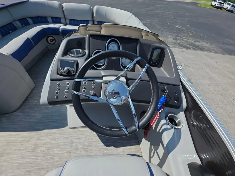 Slide: The Image of 2021 Bennington Q 23 Swingback boat interior with blue and gray seating. - 6