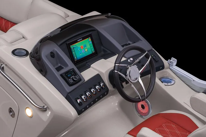 Slide: The Image of 2021 Bennington Q 23 Swingback boat interior with blue and gray seating, docked by a lake. - 17