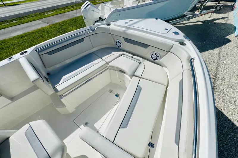 Slide: The Image of 2026 Sailfish 252 CC boat interior with cushioned seating and speakers. - 13