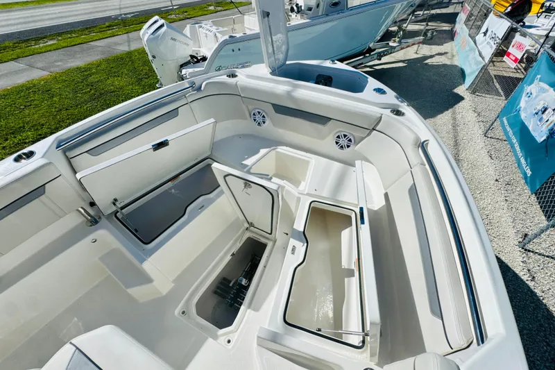 Slide: The Image of 2026 Sailfish 252 CC boat interior with open storage compartments and seating. - 14