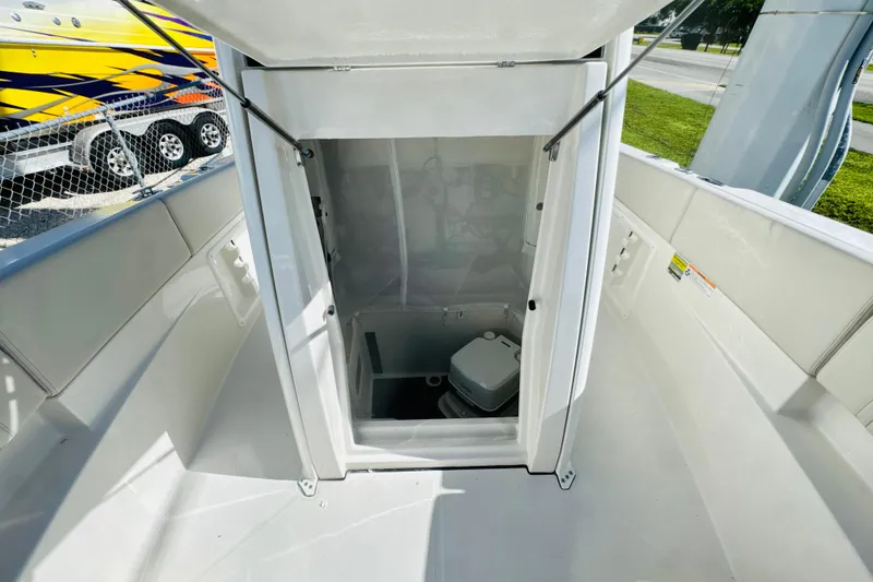 Slide: The Image of 2026 Sailfish 252 CC boat interior with open hatch and visible toilet. - 16