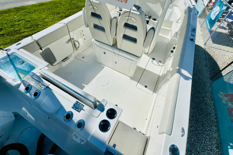 Slide: The Image of 2026 Sailfish 252 CC boat interior with seating and fishing rod holders. - 6
