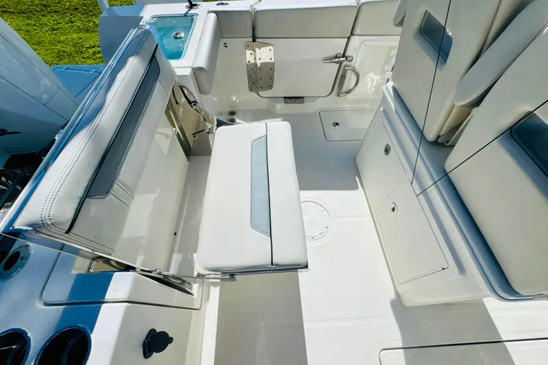 Slide: The Image of 2026 Sailfish 252 CC boat interior with white seating and storage compartments. - 8