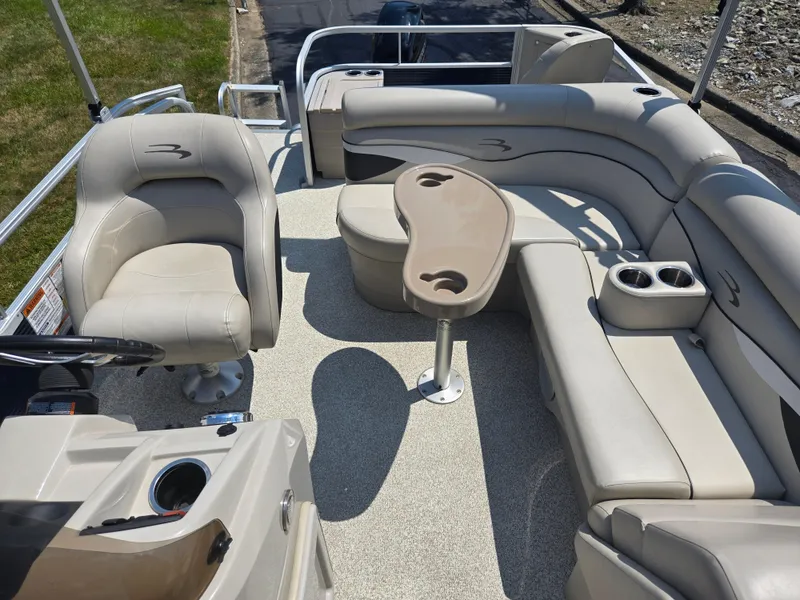 Slide: The Image of 2019 Bennington 188 SFV pontoon boat interior with beige seating and table. - 12