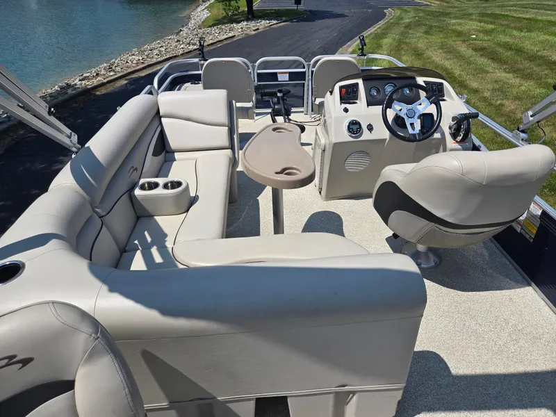 Slide: The Image of 2019 Bennington 188 SFV pontoon boat interior with plush seating and steering console. - 16
