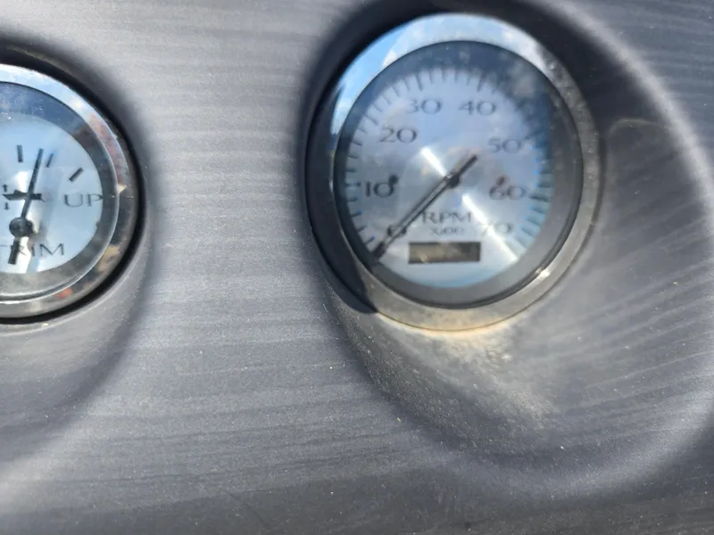 Slide: The Image of Close-up of 2019 Bennington 188 SFV dashboard gauges, showing RPM and trim indicators. - 18
