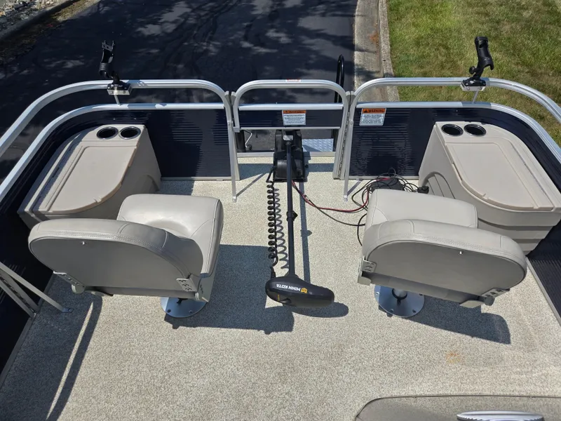 Slide: The Image of 2019 Bennington 188 SFV boat interior with two seats and fishing rod holders. - 19