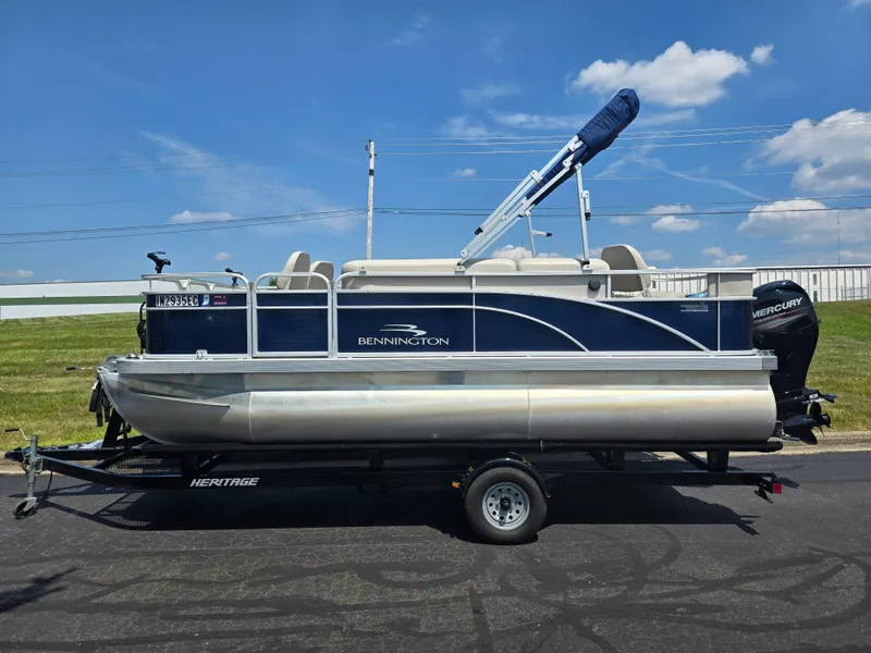 Slide: The Image of 2019 Bennington 188 SFV pontoon boat on trailer under clear blue sky. - 4