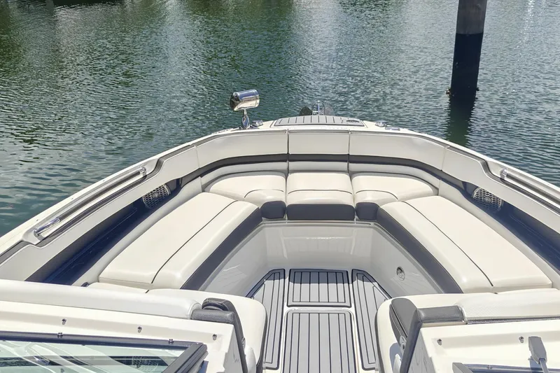 Slide: The Image of 2018 Sea Ray SLX 310 boat interior with luxurious seating and modern dashboard. - 19