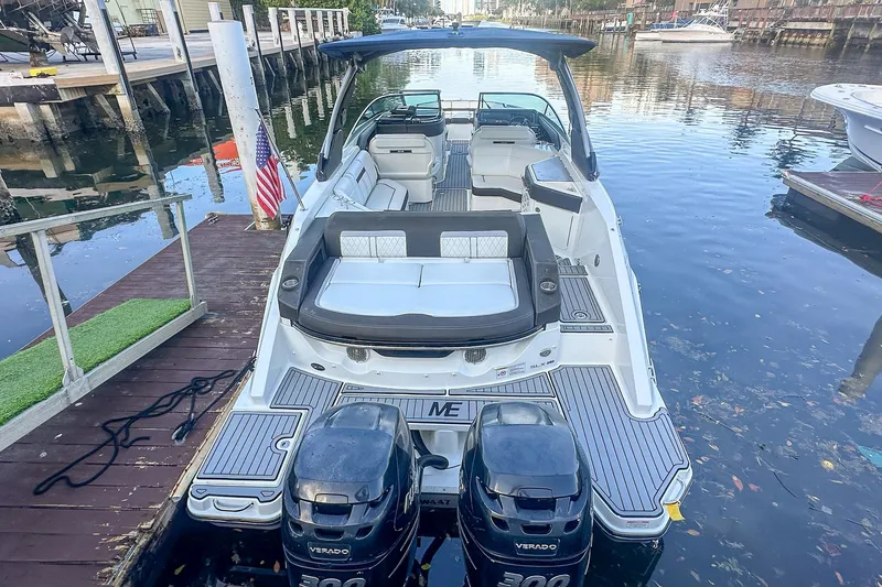 Slide: The Image of 2018 Sea Ray SLX 310 boat on trailer at Marine Connection dealership. - 2