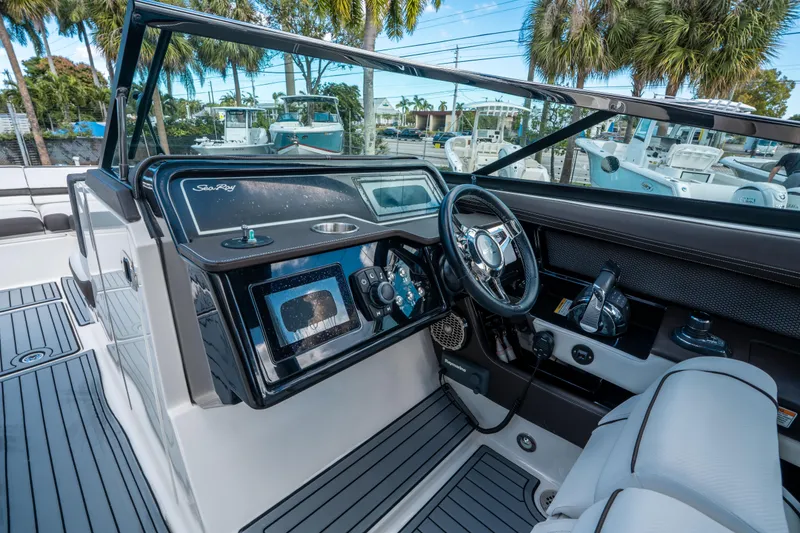 Slide: The Image of 2018 Sea Ray SLX 310 boat cockpit with modern controls and steering wheel. - 21