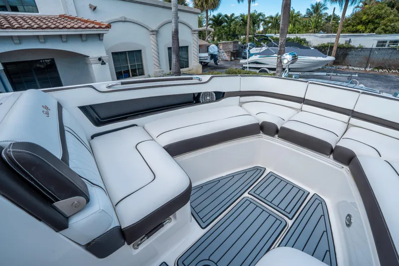 Slide: The Image of Luxurious seating area on a 2018 Sea Ray SLX 310 boat, featuring elegant upholstery. - 24