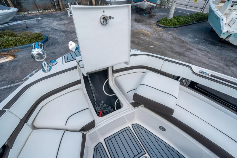 Slide: The Image of 2018 Sea Ray SLX 310 boat interior with open anchor storage compartment. - 26