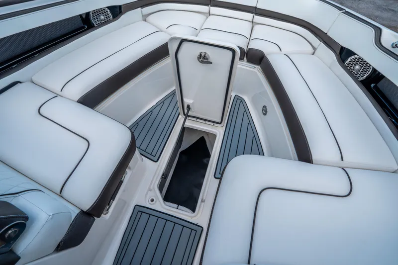 Slide: The Image of Luxurious interior of 2018 Sea Ray SLX 310 boat with white seating and storage. - 29