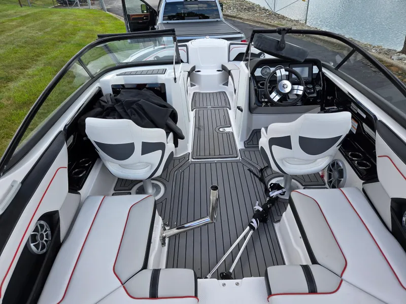 Slide: The Image of 2018 Yamaha Boats 212X interior with sleek seating and modern dashboard design. - 10