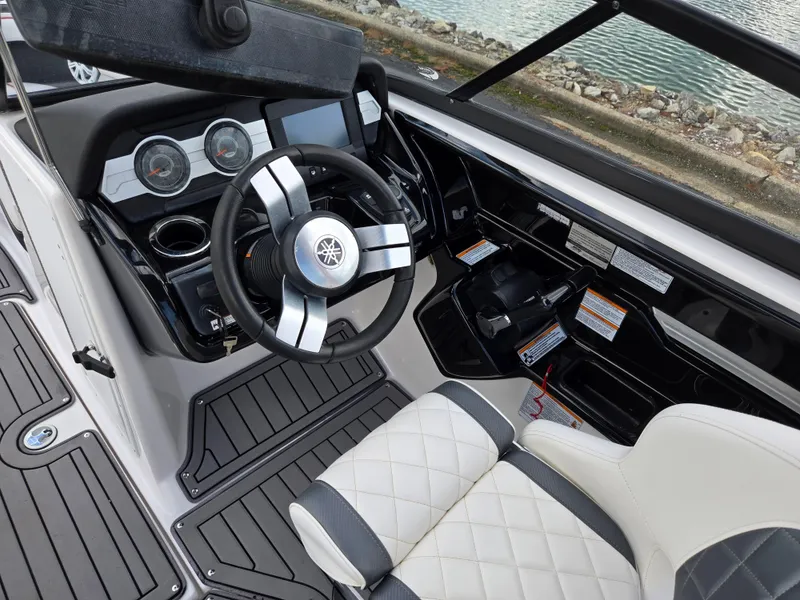 Slide: The Image of 2018 Yamaha Boats 212X cockpit with steering wheel and dashboard controls. - 12