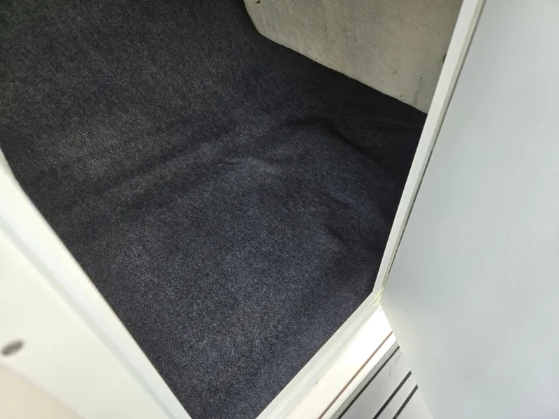 Slide: The Image of Carpeted interior storage space of a 2018 Yamaha Boats 212X. - 16