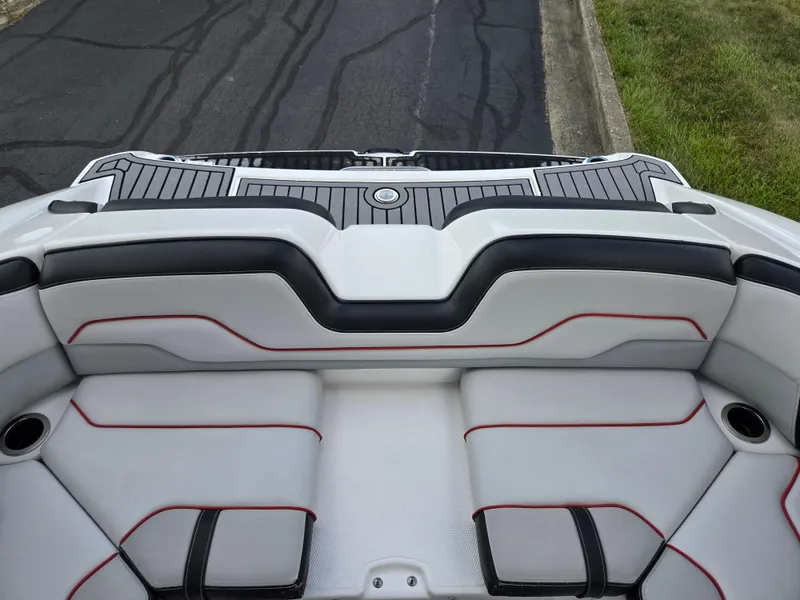 Slide: The Image of 2018 Yamaha Boats 212X interior seating with sleek design and red accents. - 24