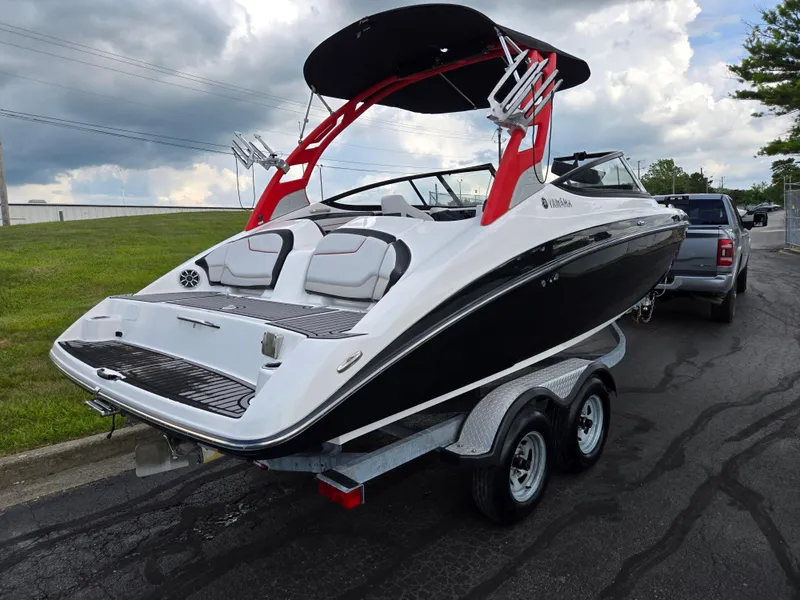 Slide: The Image of 2018 Yamaha Boats 212X on trailer, black and white design, parked outdoors. - 3