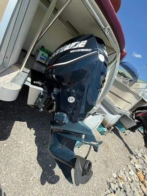 Slide: The Image of 2005 Avalon EXCALIBER 2325 boat with Evinrude outboard motor, parked on gravel. - 11