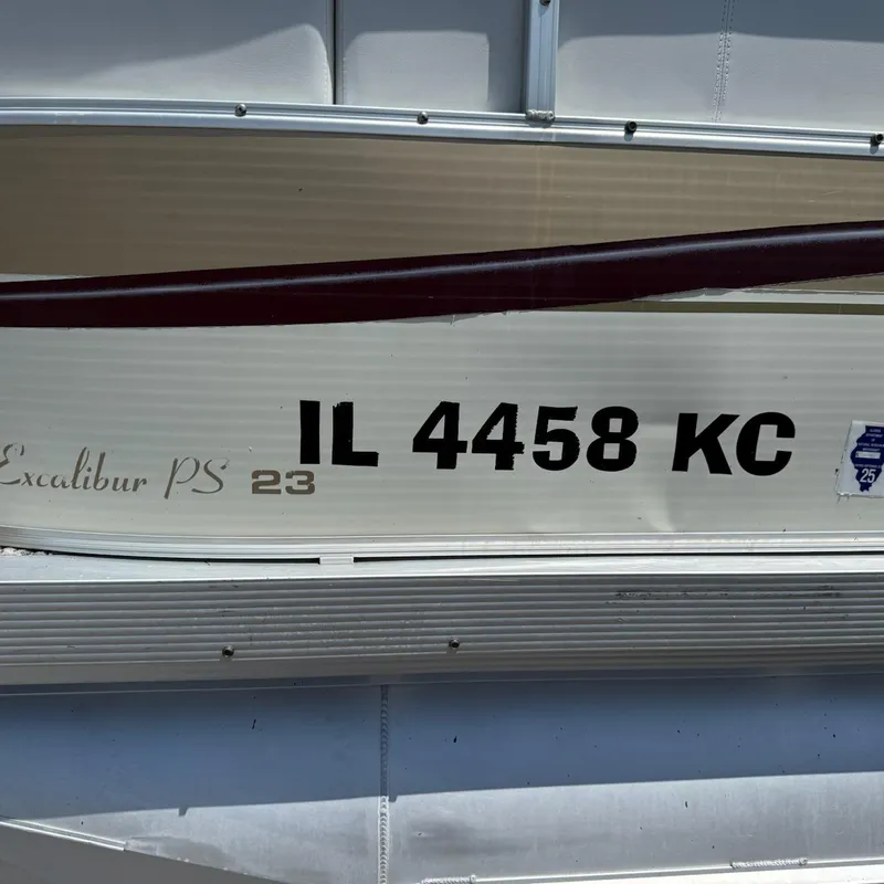 Slide: The Image of 2005 Avalon EXCALIBER 2325 boat with registration IL 4458 KC displayed on the side. - 4