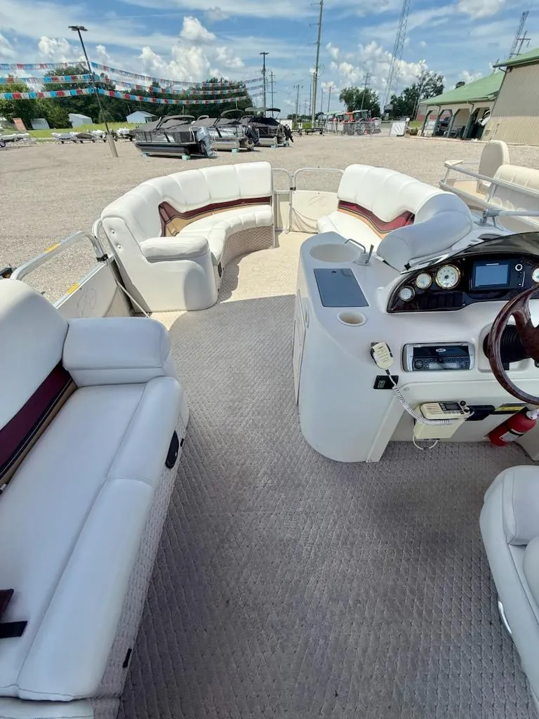Slide: The Image of Interior of 2005 Avalon EXCALIBER 2325 boat with plush seating and control panel. - 8