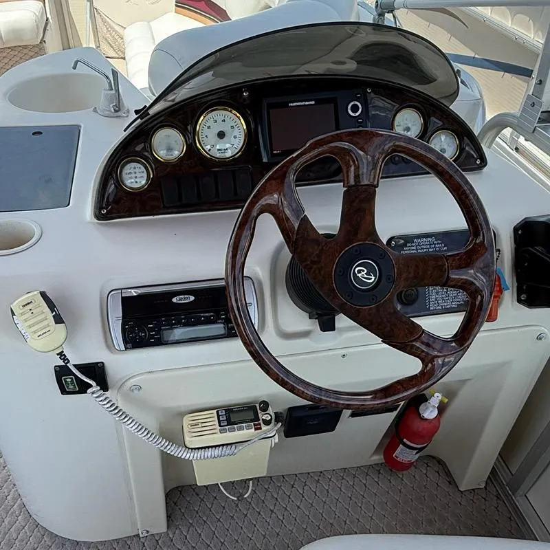 Slide: The Image of Steering console of 2005 Avalon EXCALIBER 2325 boat with wood-grain wheel and gauges. - 9