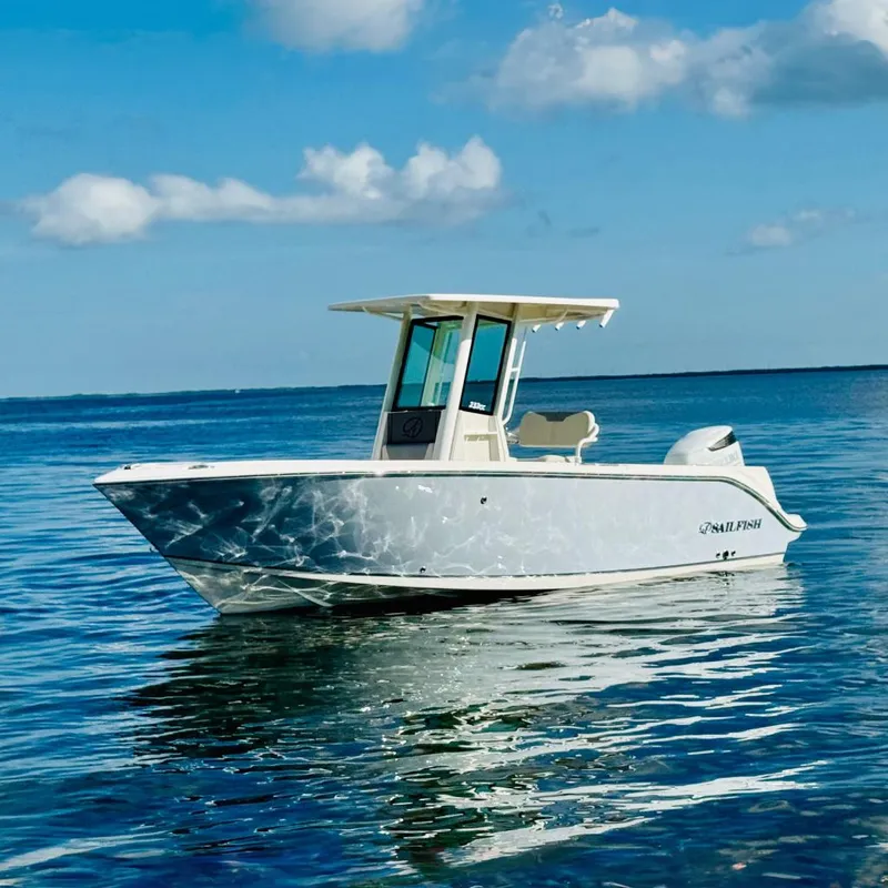 The Image of 2026 Sailfish 232 CC boat on calm ocean waters under a clear blue sky. - 0