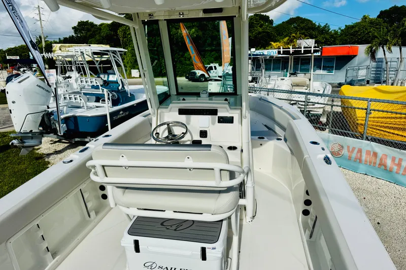 Slide: The Image of 2026 Sailfish 232 CC boat interior with steering console and seating. - 10