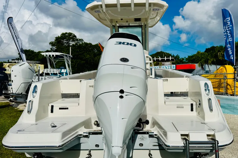 Slide: The Image of 2026 Sailfish 232 CC boat with powerful 300 HP engine, displayed outdoors. - 12
