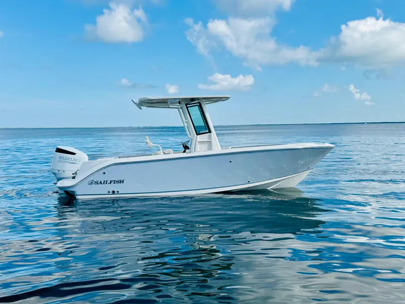 Slide: The Image of 2026 Sailfish 232 CC boat on calm ocean waters under blue sky. - 3