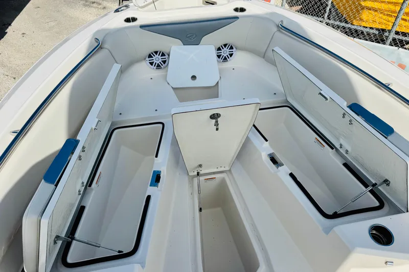 Slide: The Image of 2026 Sailfish 232 CC boat interior with open storage compartments and seating. - 6