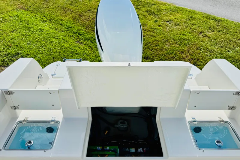 Slide: The Image of 2026 Sailfish 232 CC boat interior with open compartments and engine view. - 7