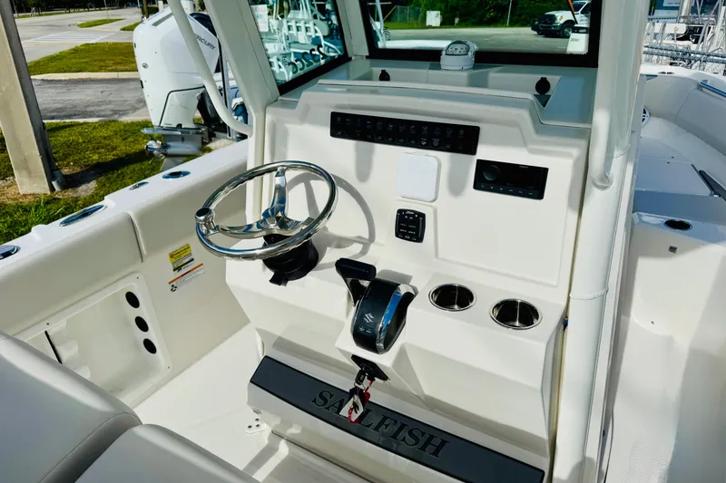 Slide: The Image of 2026 Sailfish 232 CC boat cockpit with steering wheel and control panel. - 8