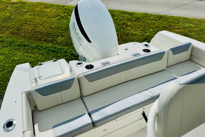 Slide: The Image of 2026 Sailfish 232 CC boat with cushioned seating and Suzuki outboard motor. - 9