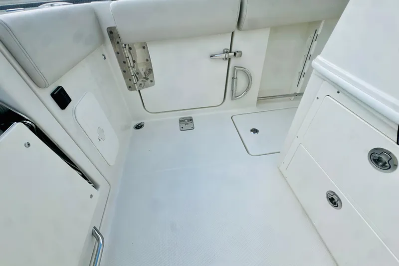 Slide: The Image of Interior of 2026 Sailfish 272 CC boat, featuring sleek white design and storage compartments. - 11