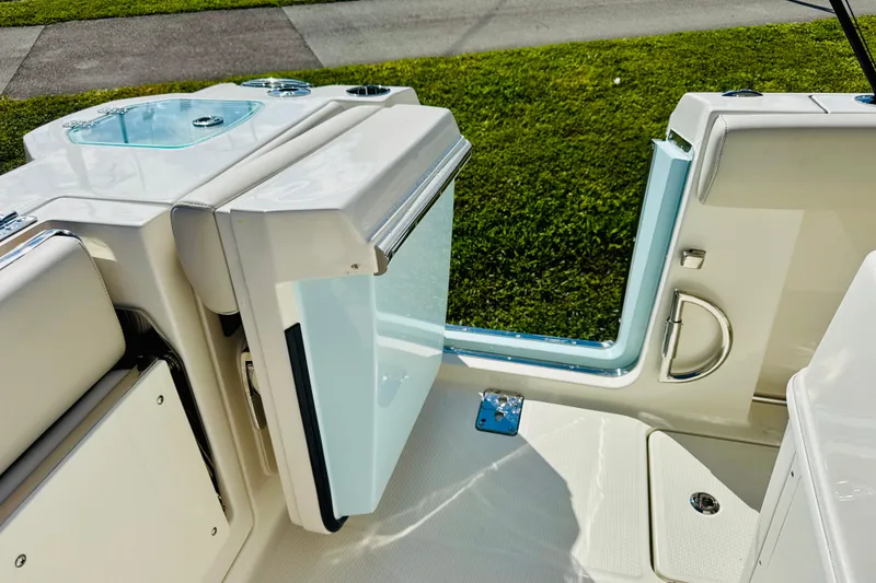 Slide: The Image of 2026 Sailfish 272 CC boat with open side door, showcasing sleek design and functionality. - 12