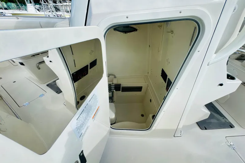 Slide: The Image of 2026 Sailfish 272 CC boat interior cabin with open door, showcasing compact design. - 16
