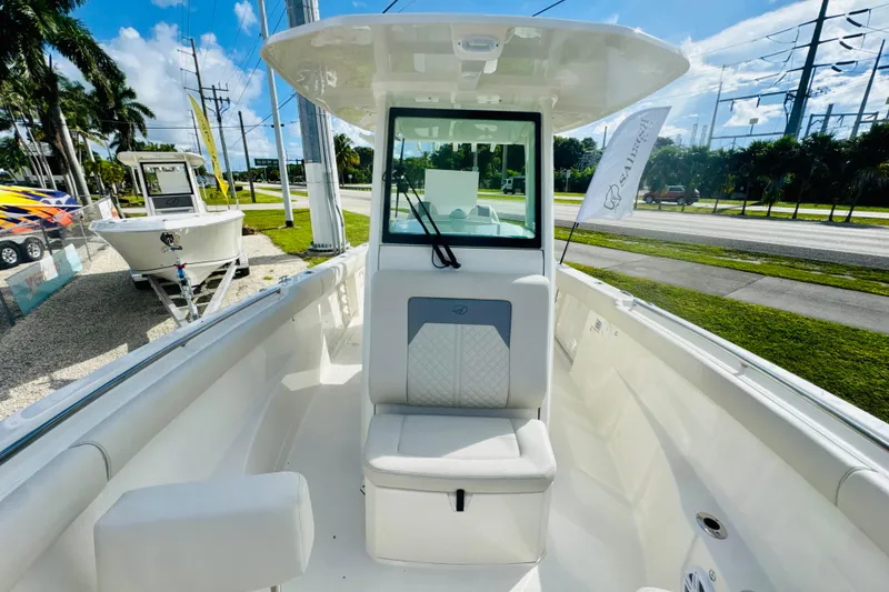 Slide: The Image of 2026 Sailfish 272 CC boat interior with seating, windshield, and outdoor view. - 18